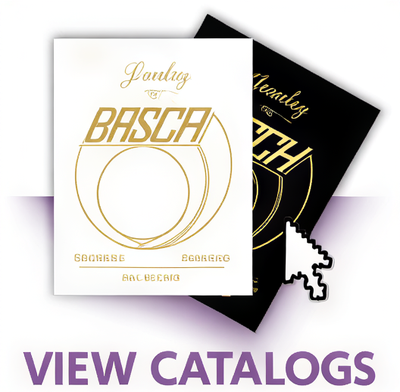 Two printed catalog/booklet covers shown on a white background with a large purple 'VIEW CATALOGS' text overlay at the bottom. The front cover is white with gold typography and a circular line graphic, reading Jane Basch' and smaller text below.
